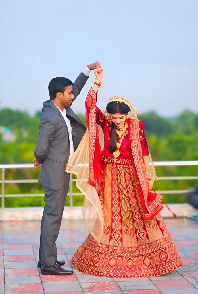 Bride and groom dancing together in a courtyard