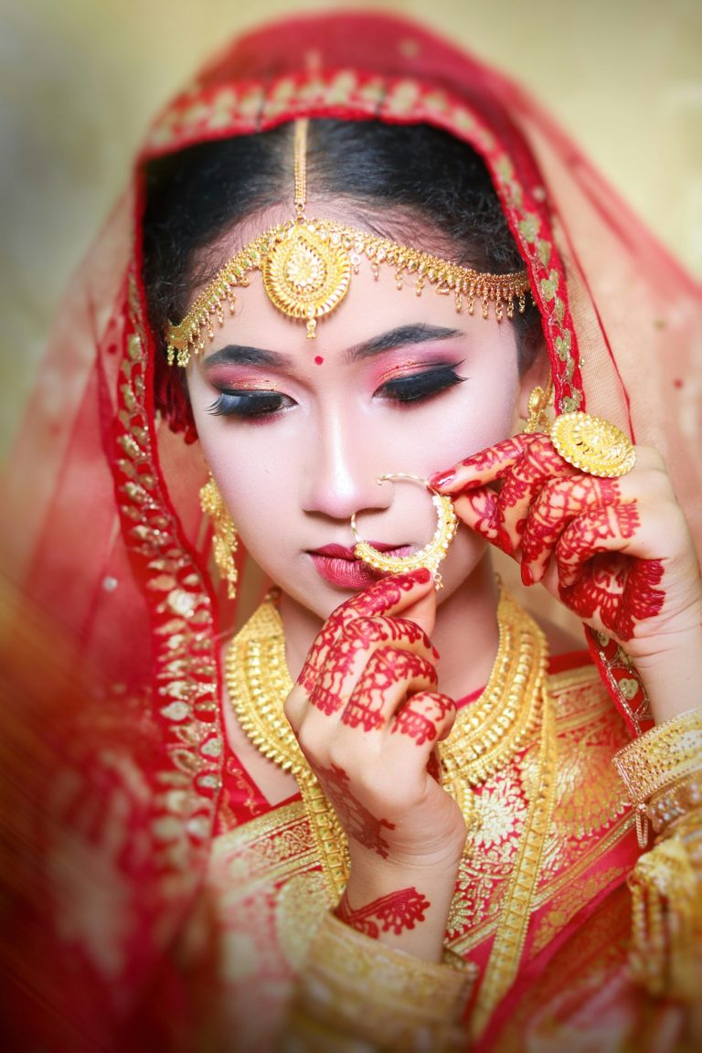 Bride wearing a headdress and a red and gold dress
